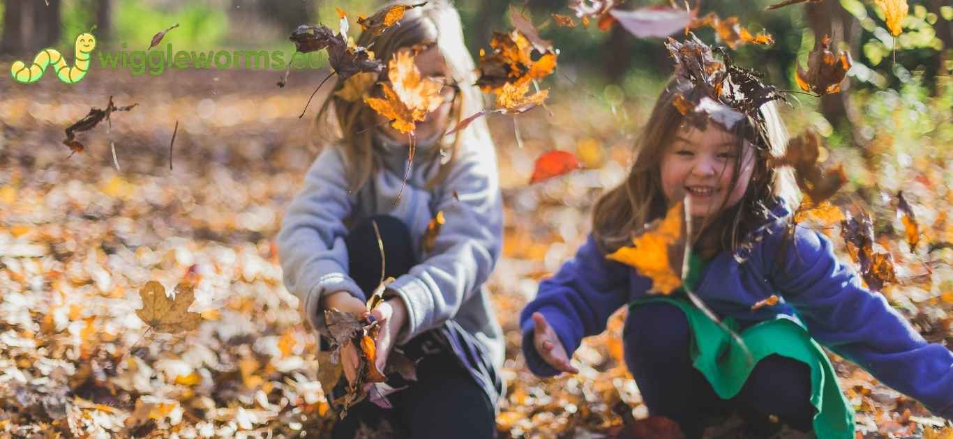 Children crafting a nature mobile indoors with leaves and twigs
