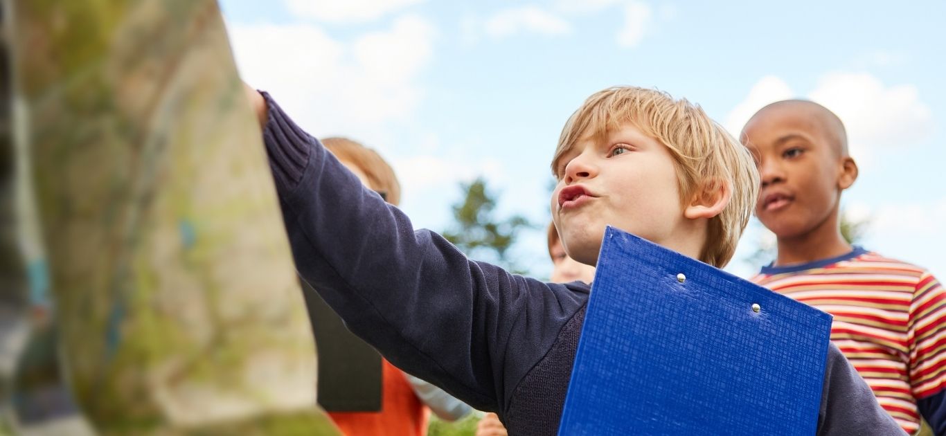 Children holding a printable scavenger hunt clipboard outdoors in Ireland